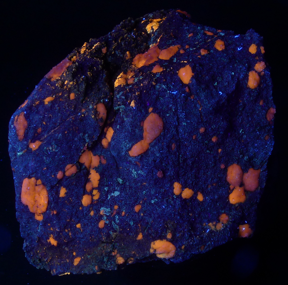 Orange gypsum in altered limestone with minor grey tremolite, LW, 8cm