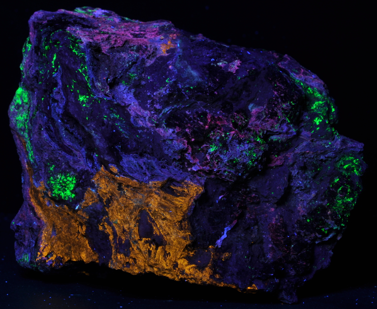 Tan sphalerite, purple smithsonite, green willemite; longwave plus shortwave; 15 cm