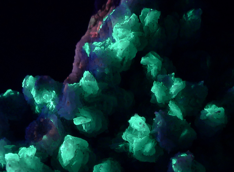 Calcite with green opal coating; field of view is 2.5 cm