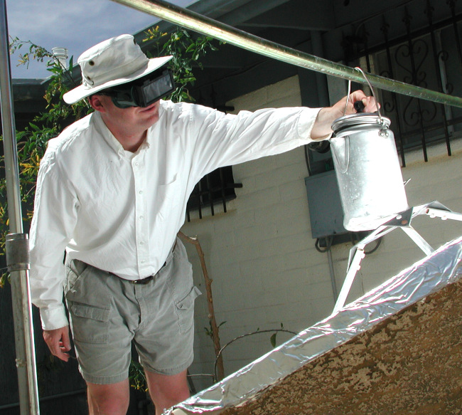 Dan checking large water pot on cooker